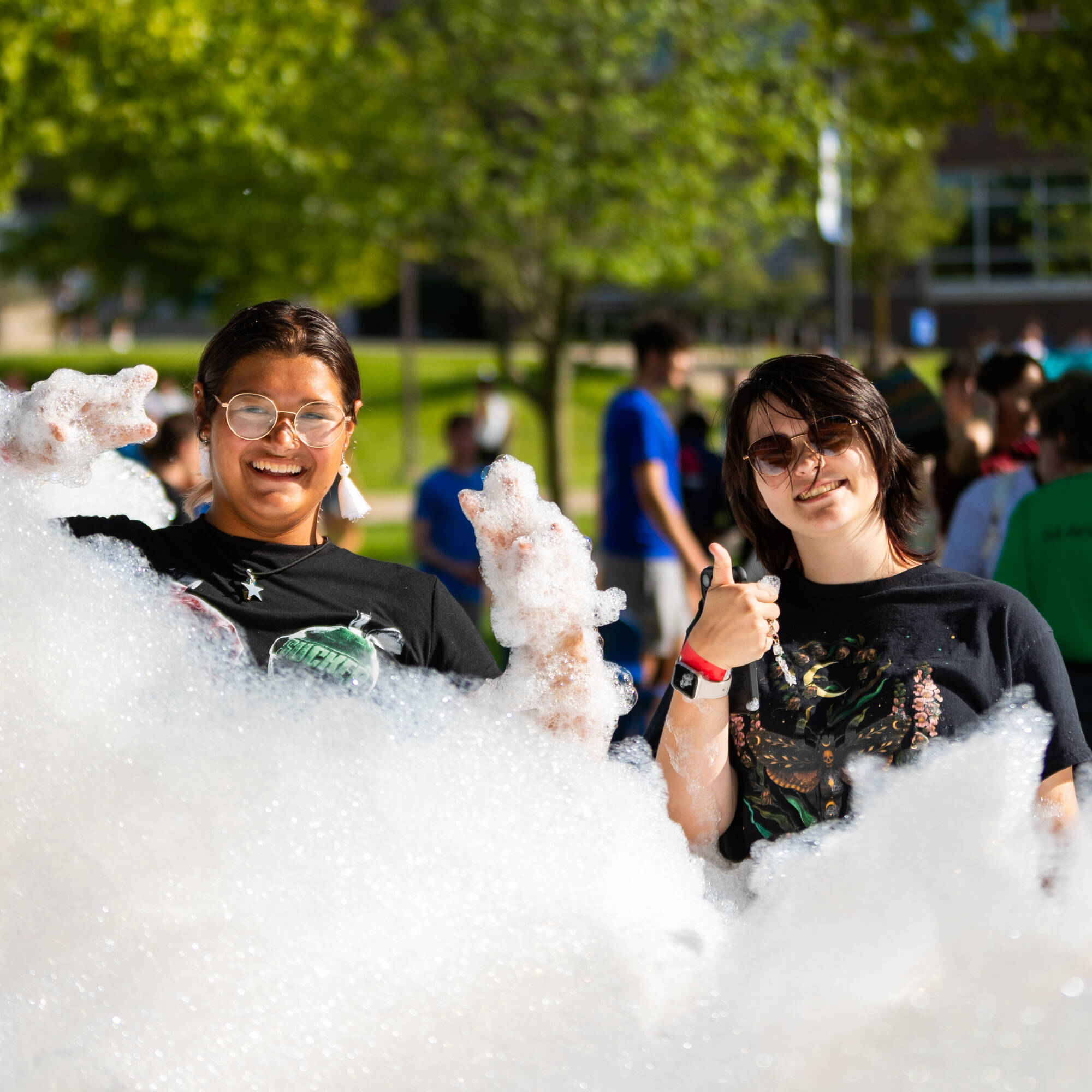 Two students in a cloud of bubbles at Laker Kickoff